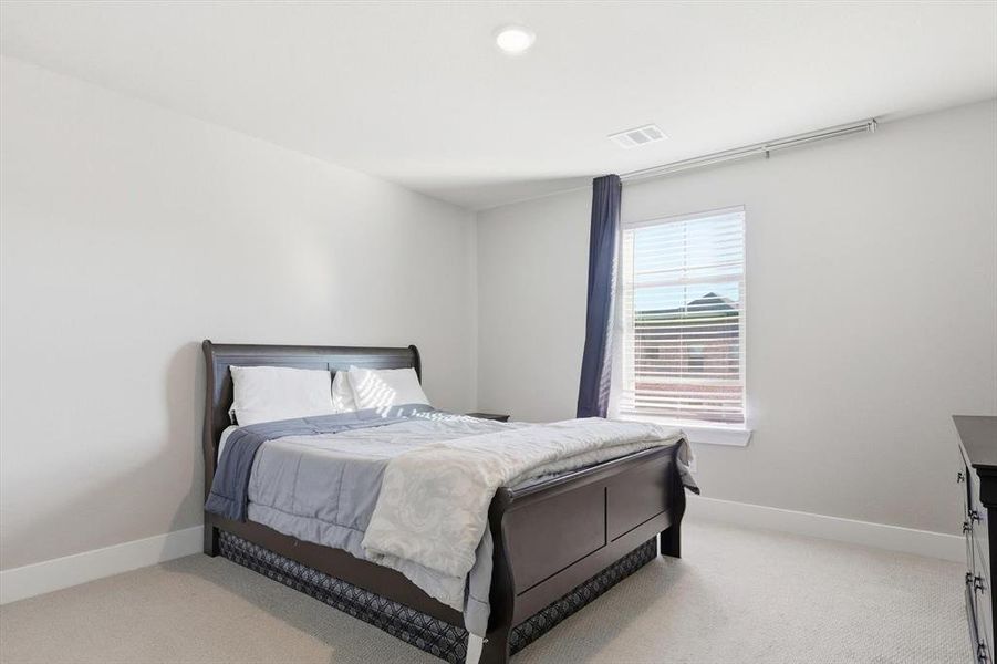 Bedroom featuring light carpet and recessed lighting