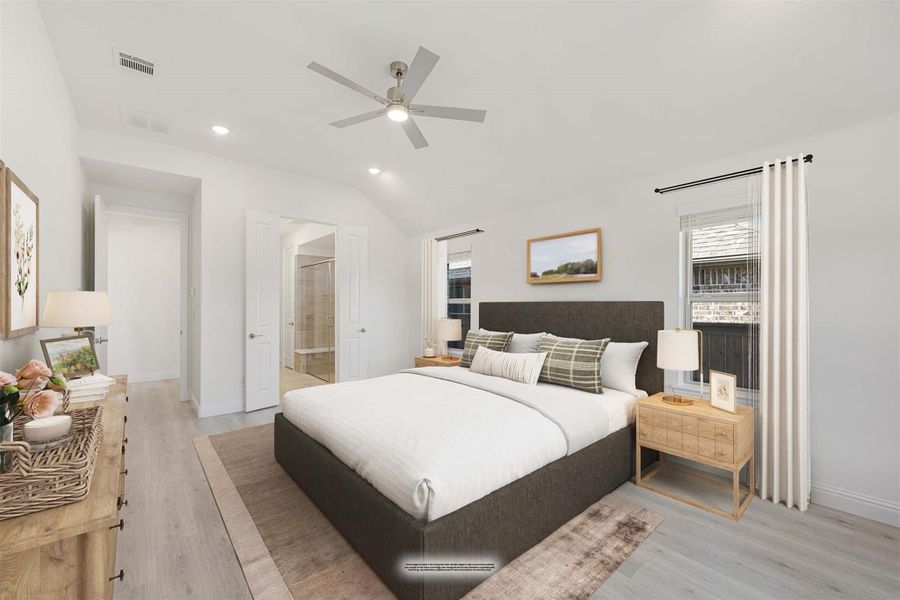 Master bedroom with vaulted ceiling, ceiling fan, hardwood floors, and ensuite bathroom entrance Master bedroom with vaulted ceiling, ceiling fan, hardwood floors, and ensuite bathroom entrance