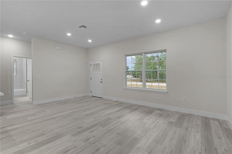 Across the living area towards Bedrooms 2 and 3, and the guest bath