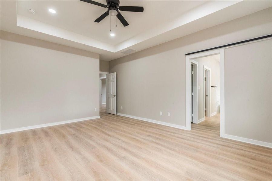 Primary bedroom with coffered ceilings.