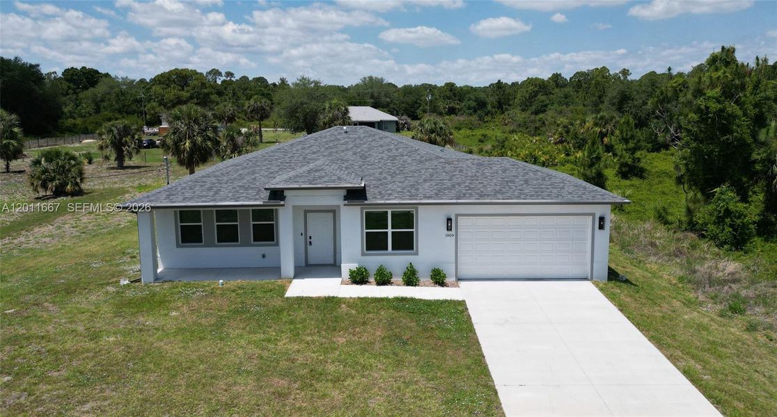 Front exterior of a new home in , Lehigh Acres, FL, highlighting curb appeal (Image 1). Front exterior of a new home in , Lehigh Acres, FL, highlighting curb appeal (Image 1).