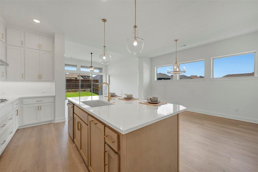 Expansive kitchen island featuring a white countertop and undermount sink