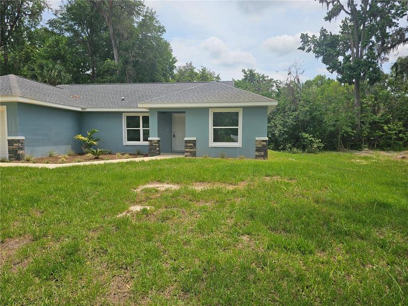 Front exterior of a new home in , Summerfield, FL, highlighting curb appeal (Image 10).