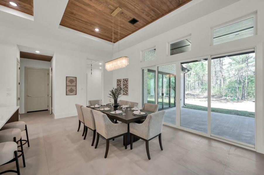 Seamless indoor-outdoor living extends to a covered patio, perfect for relaxing, dining, or entertaining while enjoying peaceful views of the property.