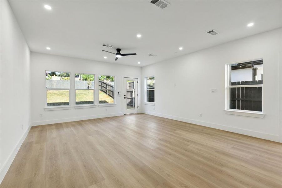 Unfurnished living room with light hardwood / wood-style floors and ceiling fan