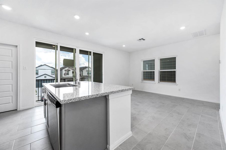 Kitchen view to the formal dining with large sliding doors for the outdoor patio. Kitchen view to the formal dining with large sliding doors for the outdoor patio.