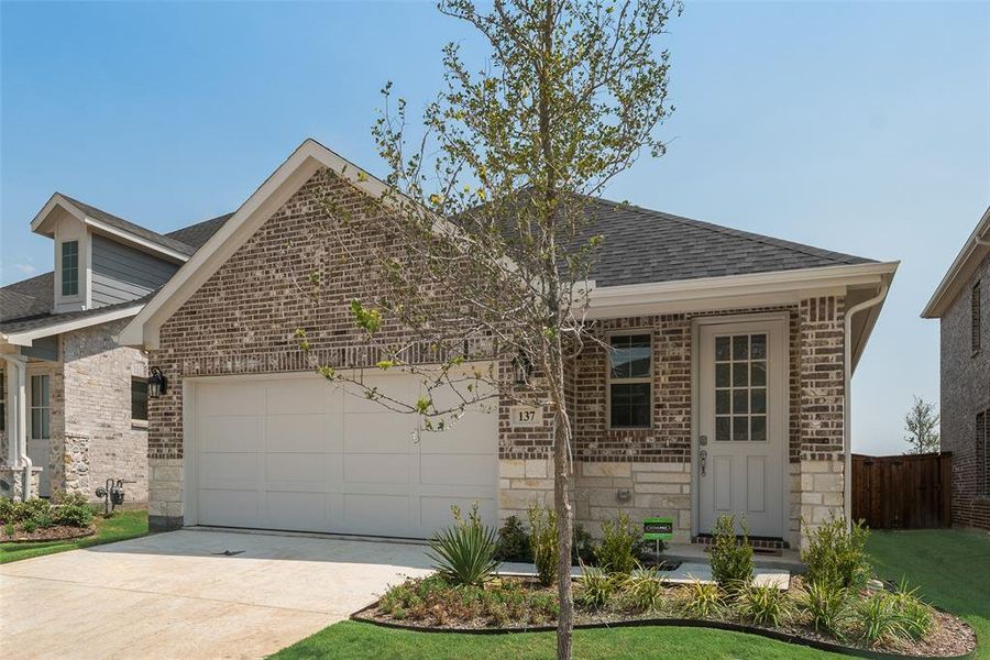 Front exterior of a new home in Spiritas Ranch, Little Elm, TX, highlighting curb appeal (Image 17). Front exterior of a new home in Spiritas Ranch, Little Elm, TX, highlighting curb appeal (Image 17).