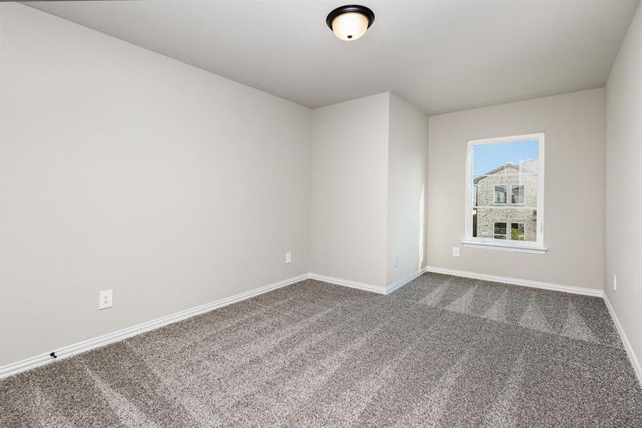 Unfurnished room featuring carpet and baseboards