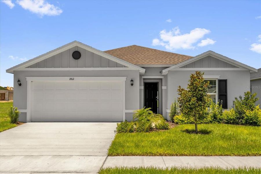 Front exterior of a new home in Hancock Crossings, Bartow, FL, highlighting curb appeal (Image 14).