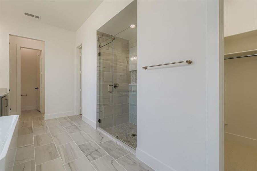 Full bathroom featuring a stall shower, vanity, and a freestanding bath Full bathroom featuring a stall shower, vanity, and a freestanding bath