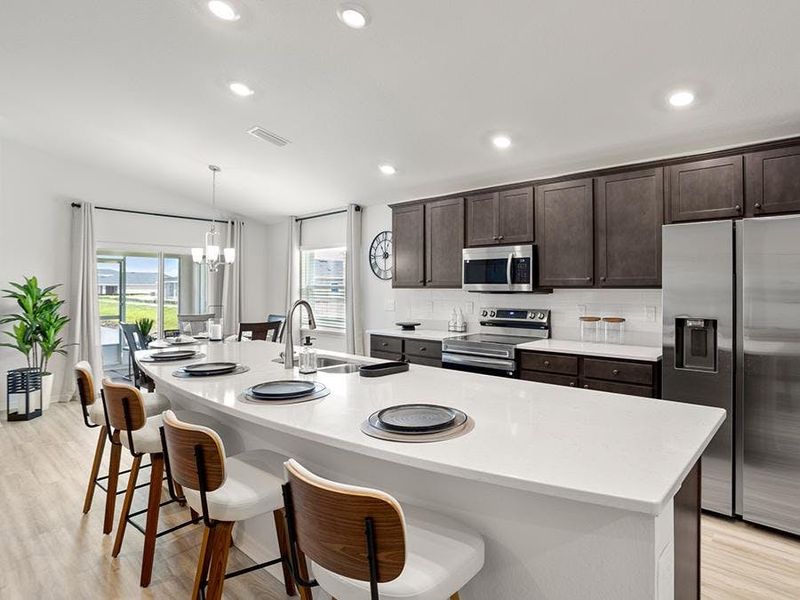 Enjoy a bright, open kitchen with a counter-height island - Parker by Highland Homes Enjoy a bright, open kitchen with a counter-height island - Parker by Highland Homes