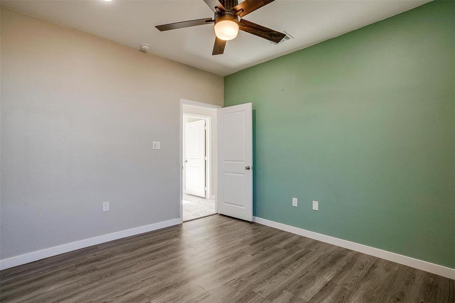 Spare room featuring hardwood / wood-style floors and ceiling fan