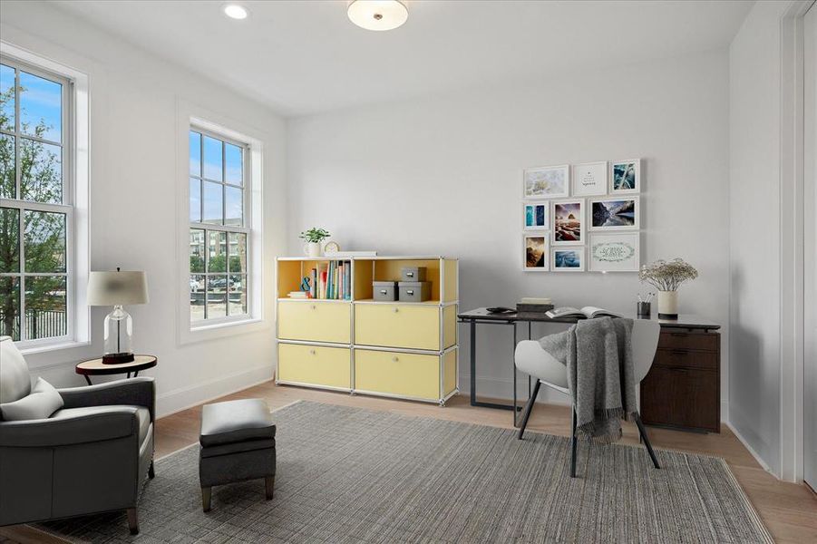 Office space featuring light wood finished floors and recessed lighting
