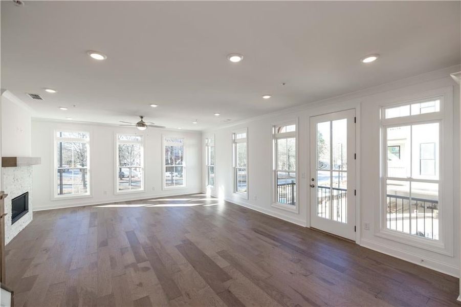 The main level open floor plan has plenty of space for a large dining table and a large sofa in the family room.