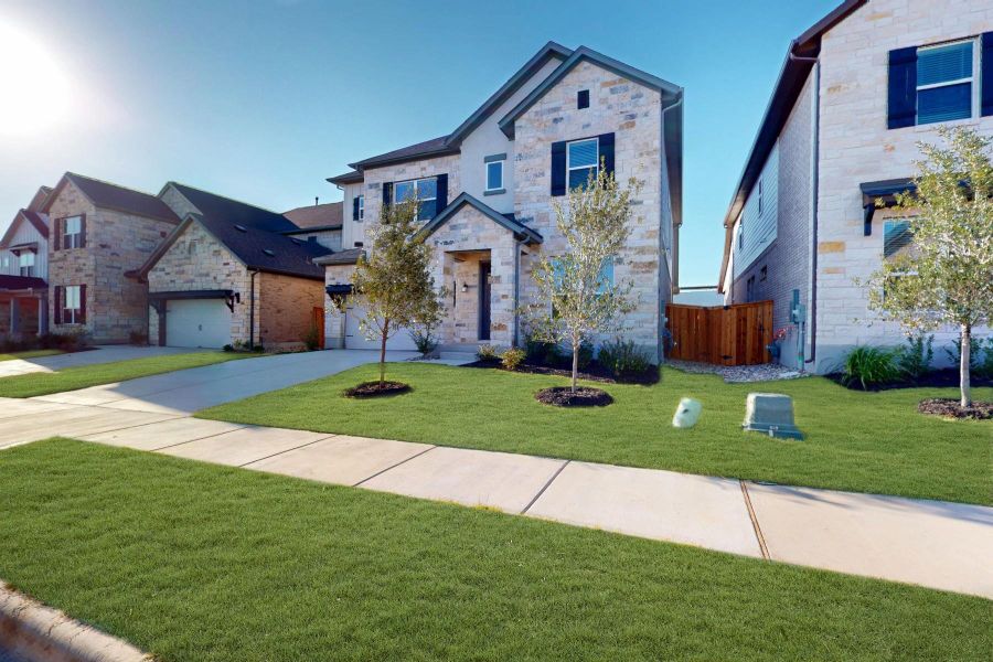 Front exterior of a new home in Edgewood, Leander, TX, highlighting curb appeal (Image 1). Front exterior of a new home in Edgewood, Leander, TX, highlighting curb appeal (Image 1).
