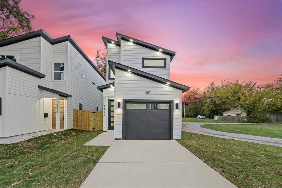 Contemporary house featuring a yard and a garage