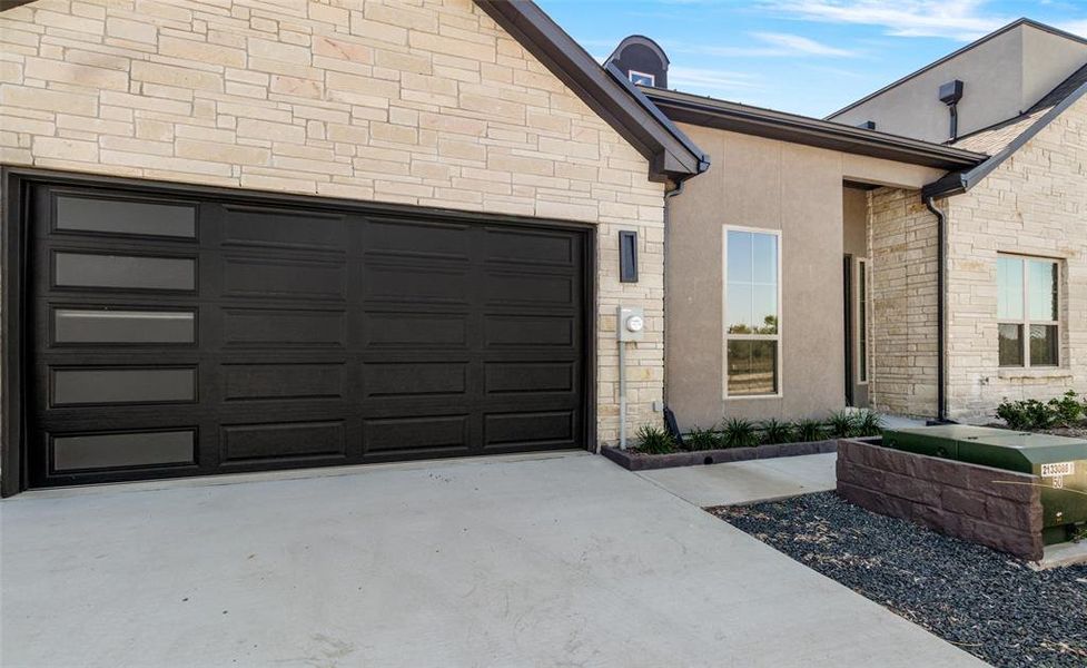 View of exterior entry with a garage