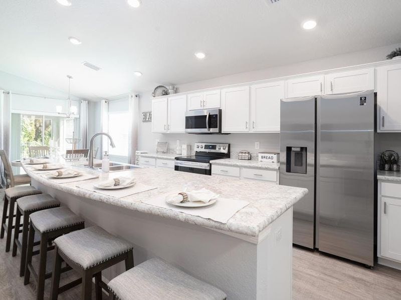 Enjoy a bright, open kitchen with 36-inch cabinets, Samsung SS appliances, and a walk-in pantry.