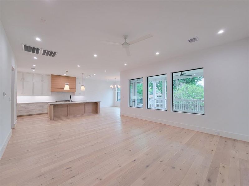 View from the living area toward the kitchen, dining area without furniture.