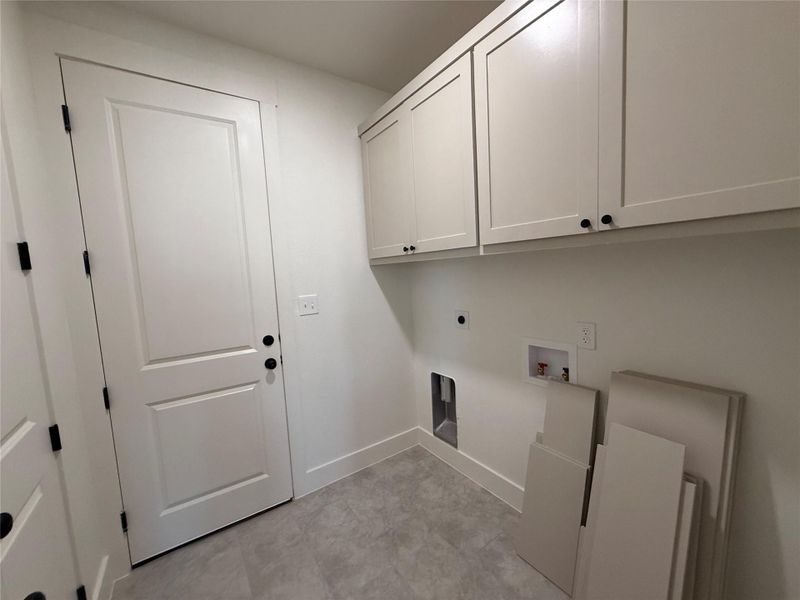 Laundry area featuring washer hookup, cabinet space, and hookup for an electric dryer