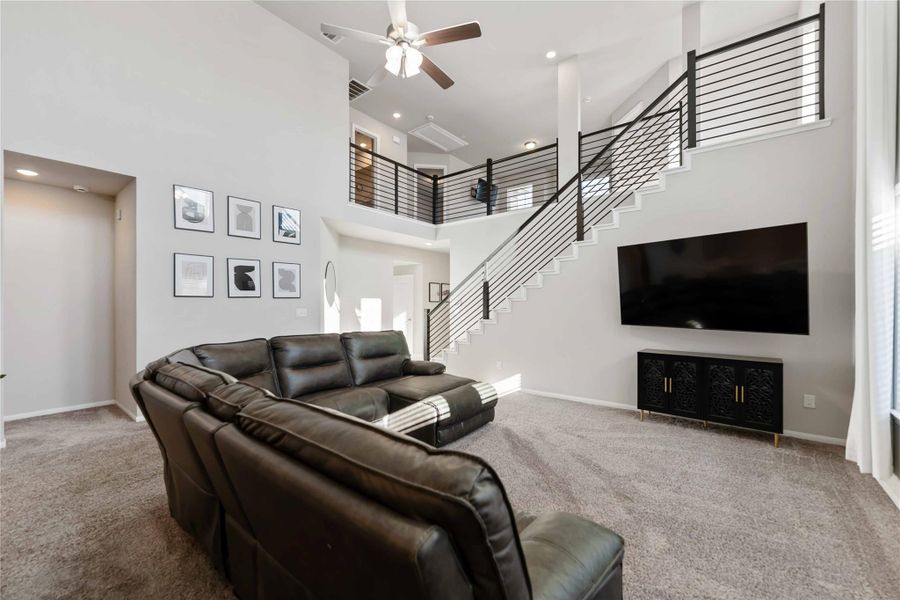 Open-concept layout connects the living, kitchen, and dining areas with soft carpeting, neutral tones, and recessed lighting. Open-concept layout connects the living, kitchen, and dining areas with soft carpeting, neutral tones, and recessed lighting.