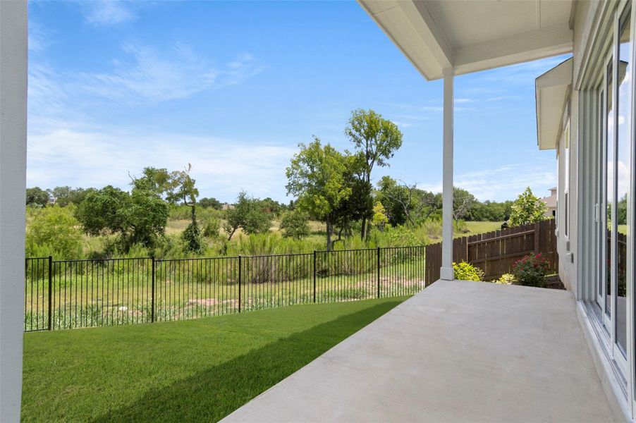 Fenced backyard with a patio