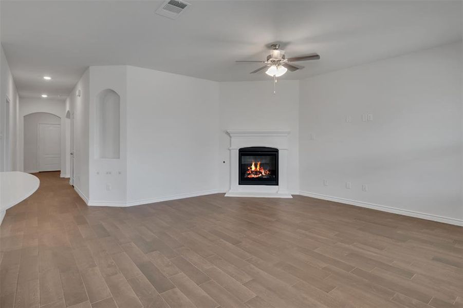 Living room with wood-type flooring and ceiling fan