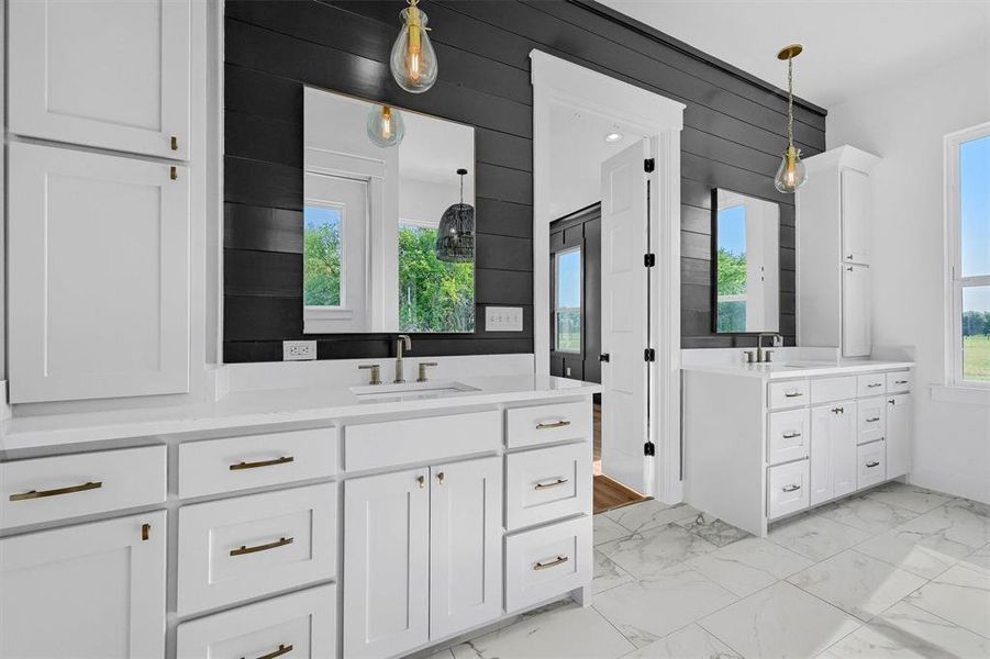 Bathroom with double vanity and tile patterned floors