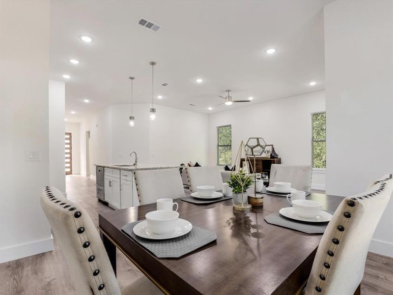 Dining space featuring light wood finished floors, recessed lighting, healthy amount of natural light, and ceiling fan