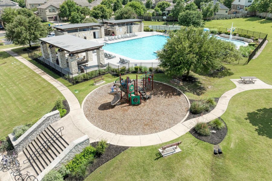 A community oasis features a refreshing pool, engaging playground, and ample green spaces.
