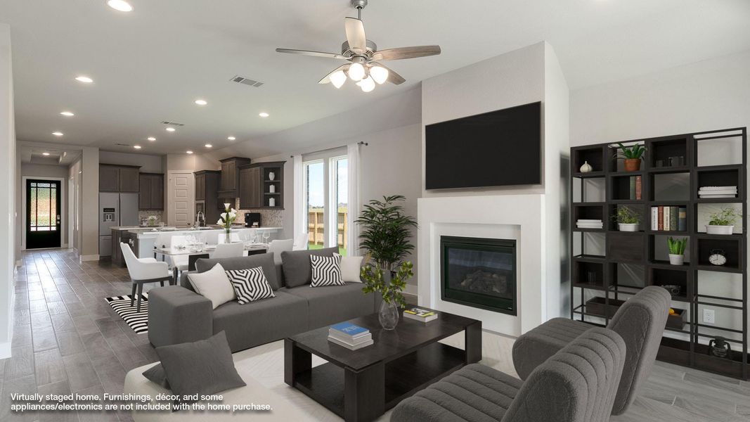 Living area with light wood-type flooring, recessed lighting, a glass covered fireplace, and a ceiling fan