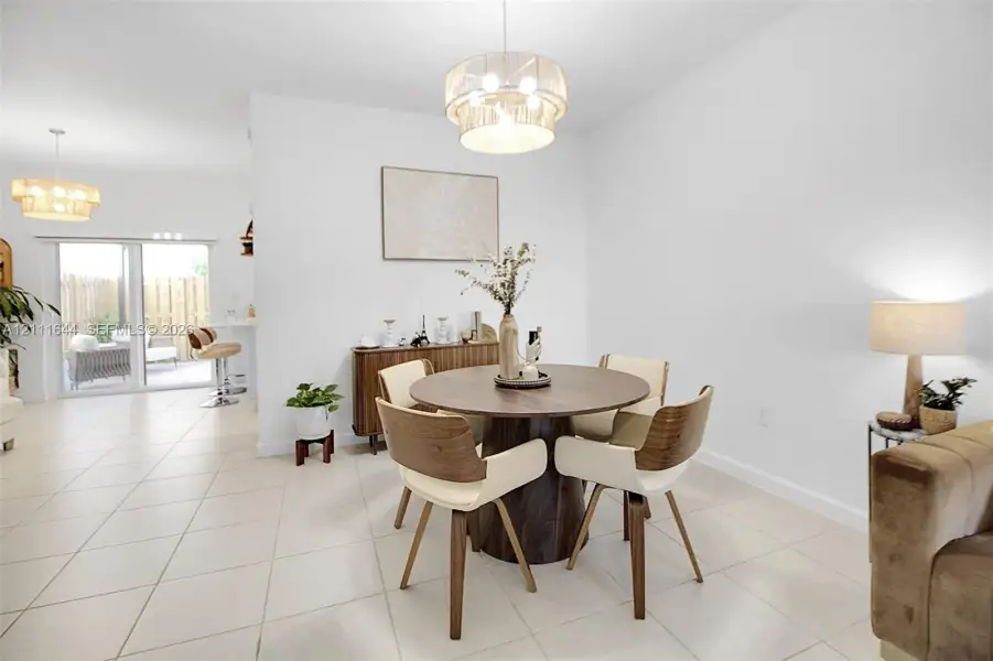 Large-format tile flooring, drum-style pendant lighting, and sliding glass doors Large-format tile flooring, drum-style pendant lighting, and sliding glass doors