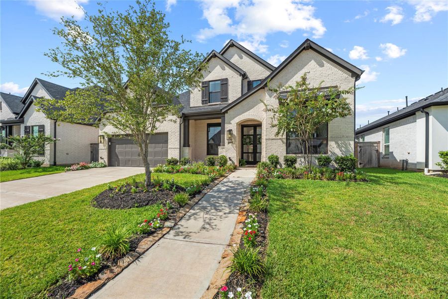 Front exterior of a new home in Sienna, Missouri City, TX, highlighting curb appeal (Image 24).