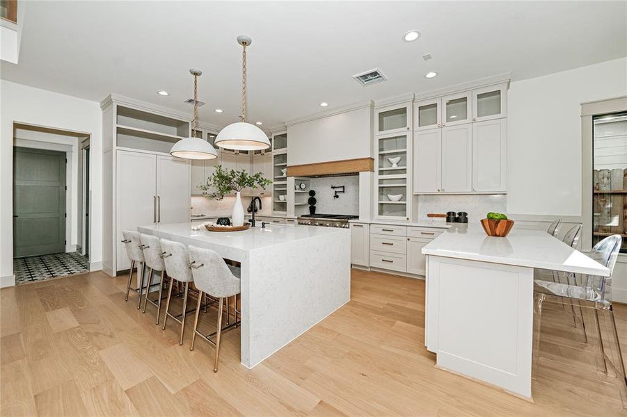 wide angle of kitchen to notice the island and peninsula seating