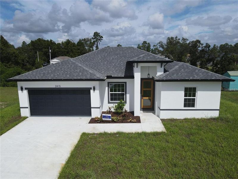 Front exterior of a new home in , Dunnellon, FL, highlighting curb appeal (Image 1).
