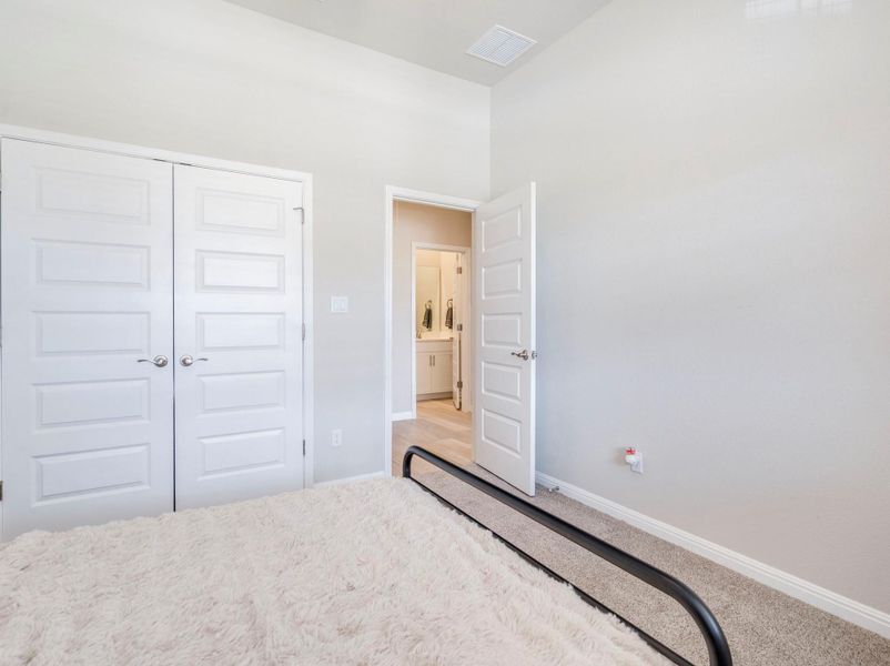 A well-lit bedroom provides direct entry to a pristine, light-filled bathroom.
