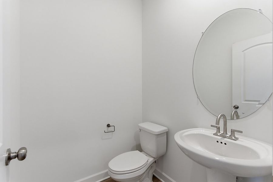 A bathroom with a round mirror. A bathroom with a round mirror.
