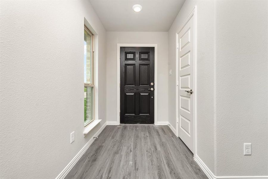 Doorway with hardwood / wood-style flooring