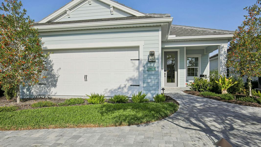 Front exterior of a new home in Boca Royale Golf & Country Club Real Estate and Homes for Sale in Englewood, FL - Neal Communities, Englewood, FL, highlighting curb appeal (Image 22). Front exterior of a new home in Boca Royale Golf & Country Club Real Estate and Homes for Sale in Englewood, FL - Neal Communities, Englewood, FL, highlighting curb appeal (Image 22).