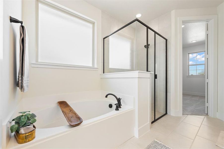 Full bathroom featuring a garden tub, a shower stall, light tile patterned floors, and recessed lighting