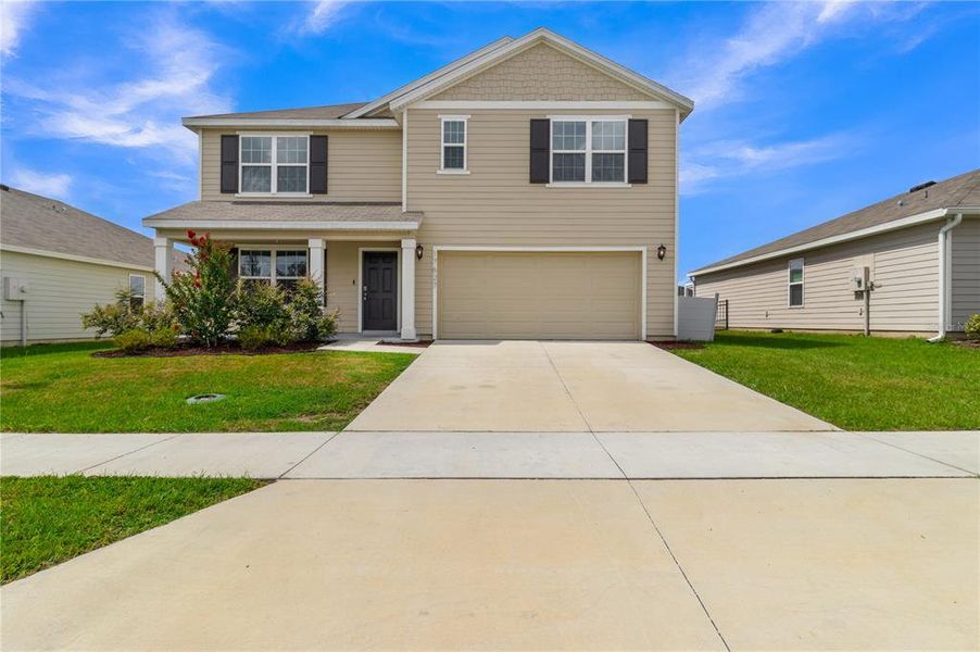 Front exterior of a new home in Briarwood, Alachua, FL, highlighting curb appeal (Image 16).