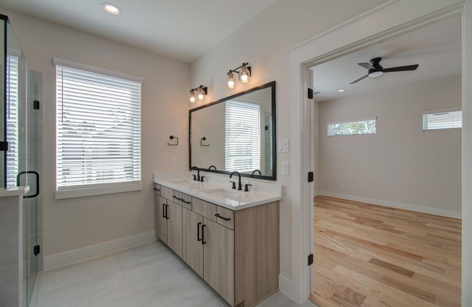 Step into your elegant en-suite oasis. Dual vanities topped with luxurious finishes, a grand mirror reflecting abundant natural light, and every detail designed to create a spa-like experience just steps from your bed. It’s your daily dose of tranquility.En-Suite Bathroom 2 – Style Meets Sophistication