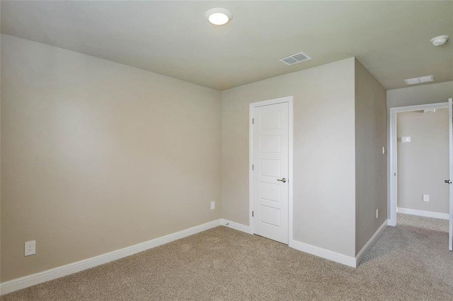 Unfurnished bedroom with light carpet and baseboards Unfurnished bedroom with light carpet and baseboards