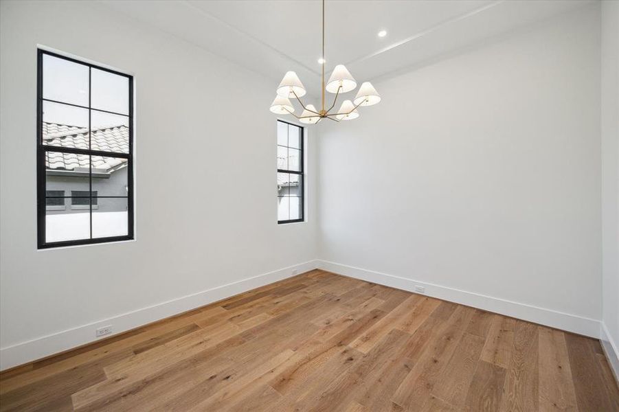 On the top floor, this sunny north-facing bedroom boasts a roomy closet, a Visual Comfort chandelier, and 7" European Engineered White Oak Flooring. Enhanced with Benjamin Moore neutral paint, it offers a serene ambiance and convenient access to a Hollywood bathroom.