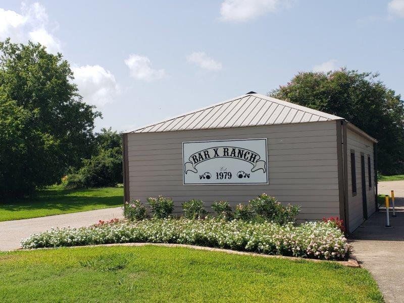Welcoming entrance to the Bar X Ranch community, known for its spacious country setting, natural surroundings, and neighborhood amenities.