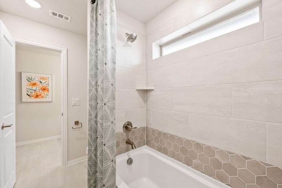 Bathroom with soaking tub, shower combo, hexagon tile surround, and small window above Bathroom with soaking tub, shower combo, hexagon tile surround, and small window above
