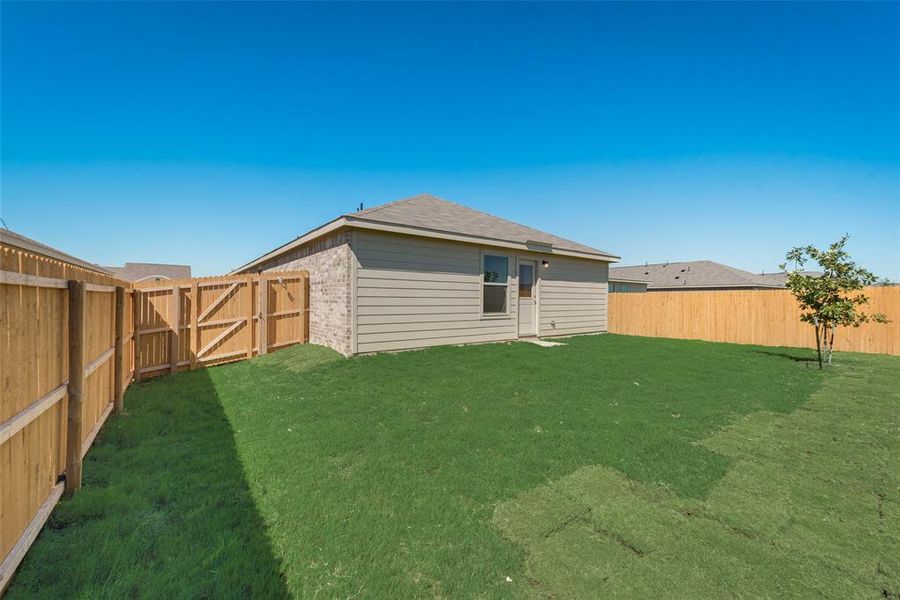 Rear view of house with a lawn