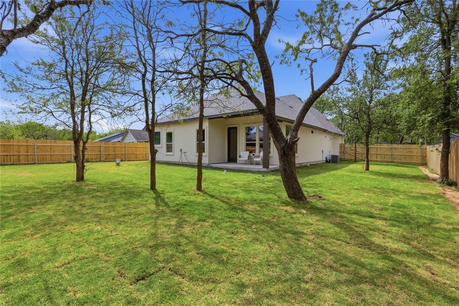Back of property featuring a patio, a fenced backyard, and stucco siding