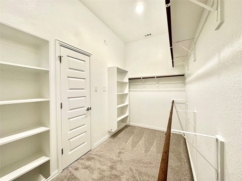 Walk in closet with light colored carpet Walk in closet with light colored carpet