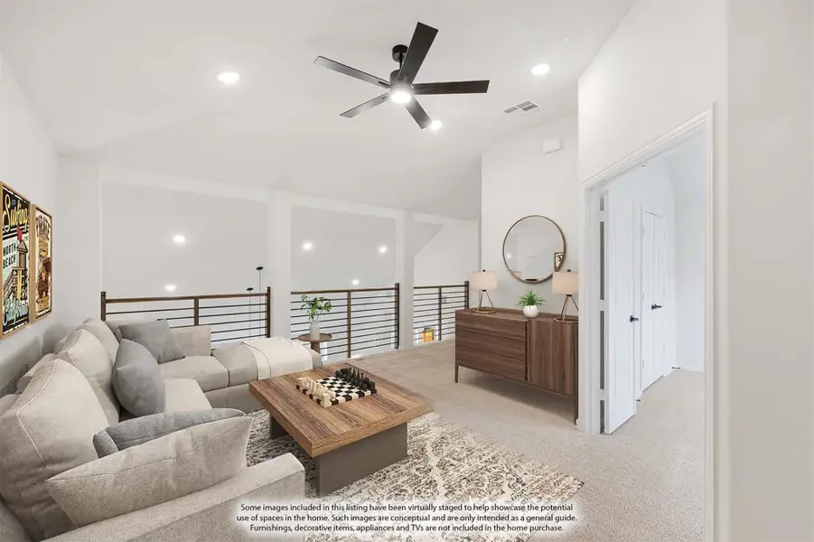 Upstairs loft living area with sectional sofa, ceiling fan, and open railing overlooking lower floor